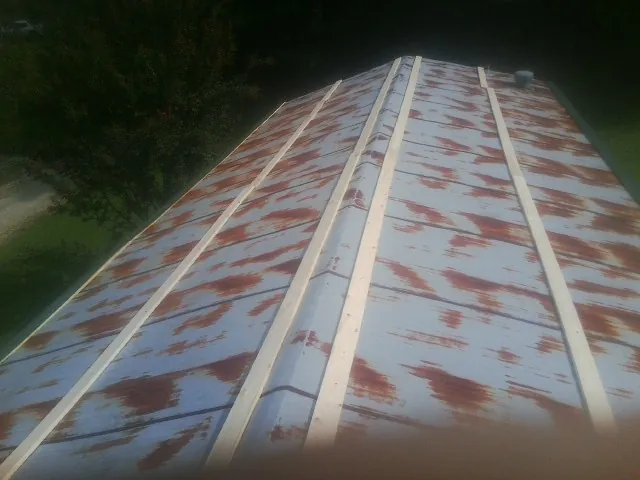 Rusted metal roof panels with new wood purlins before replacement — Storm Damage Roof Repair in Brea by Roofing Brothers